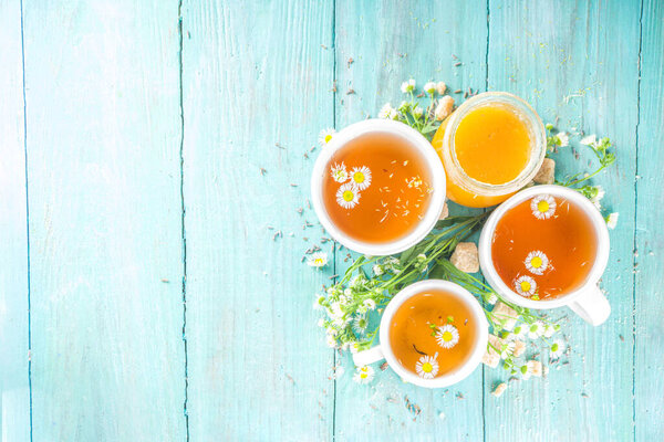 Chamomile and honey natural organic tea, on a blue wooden table