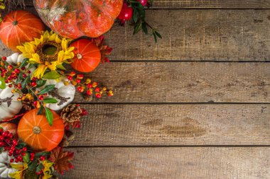 Geleneksel dekor ile şenlikli sonbahar arkaplanı, balkabakları, böğürtlenler, meyveler, eski ahşap arka planda yapraklar. Şükran Günü ve Cadılar Bayramı tebrik kartı konsepti. Sonbahar düzleşmesi