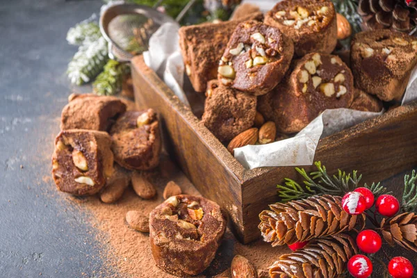 Traditional italian winter and Christmas dessert. Homemade chocolate salami sausage, on festive  background with Christmas decoration