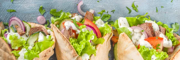 Turkish kebab wrap shawarma  sandwiches. Tasty fresh wrap sandwiches with beef meat and vegetables, Traditional Middle Eastern snack.