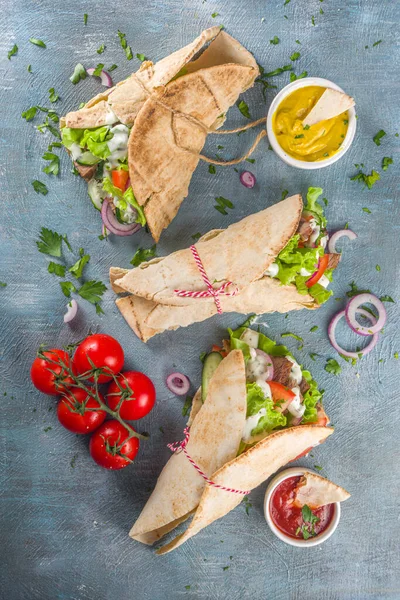 Turkish kebab wrap shawarma  sandwiches. Tasty fresh wrap sandwiches with beef meat and vegetables, Traditional Middle Eastern snack.