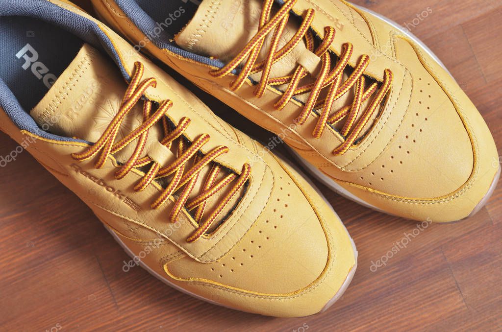 Kiev, Ukraine - May 30, 2018: Reebok light brown men's sneakers on a wooden background