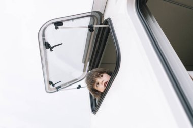 Küçük çocuk kamyonet ve karavan pencereden görebiliyor