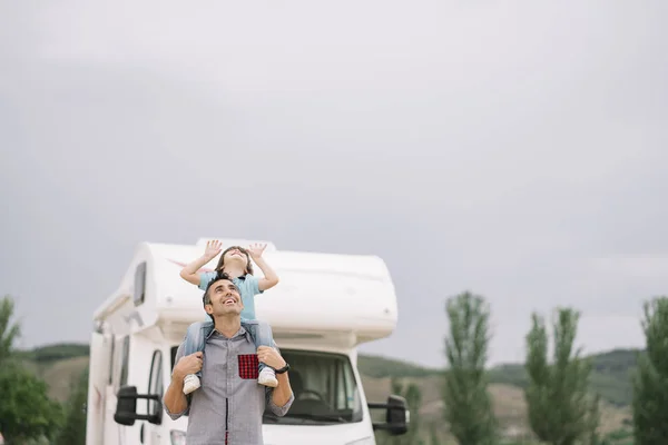 Father and son with the holiday caravan