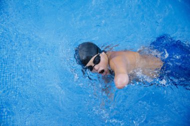 Young boy who does swimming and he lacks an arm, disabled person clipart