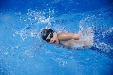 Young boy who does swimming and he lacks an arm, disabled person clipart