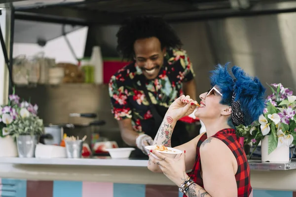 Gıda satıcı gülümseyen gıda bekleyen müşteriye eller