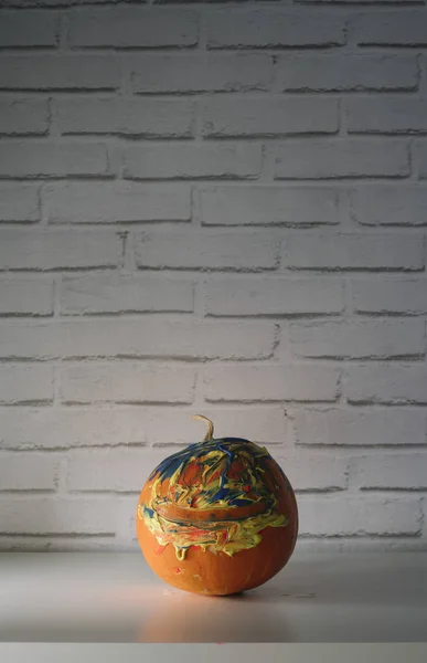 Halloween pumpkin, on white table and wall background.
