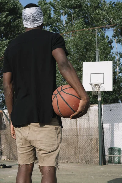 Afro Man Basketball Player In A Street Court