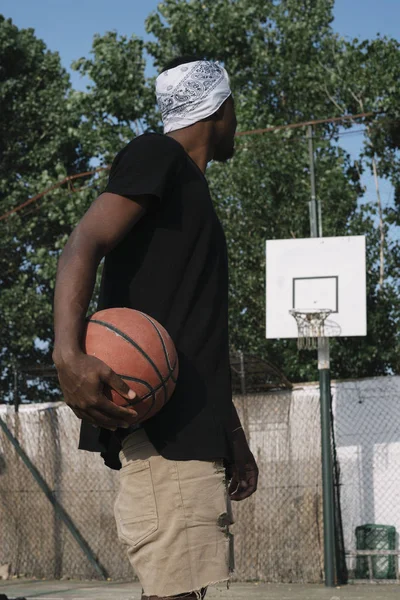 Afro Man Basketball Player In A Street Court