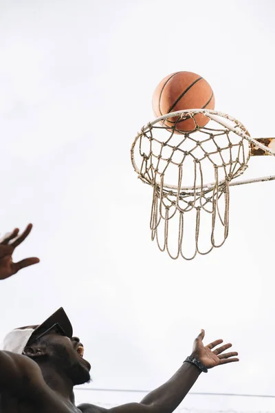 Hand Reaching To Score At Basketball Game