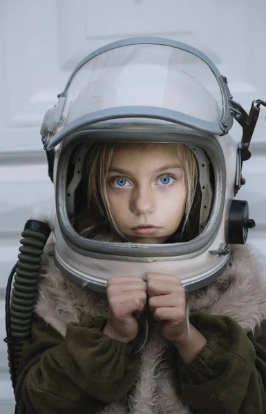 Little Girl with blue eyes and astronaut helmet