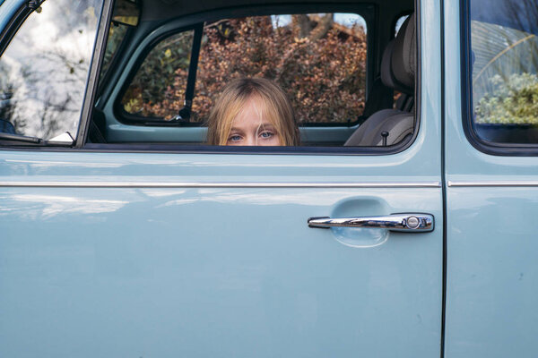 Little blonde girl in the car window
