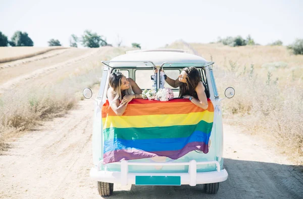 Two happy lesbian women in the old van