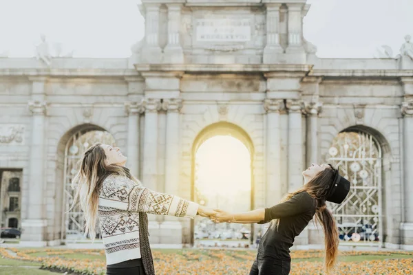 Attractive young lesbian couple in the street of Madrid city