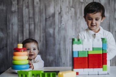 İki mutlu bebek oyuncak bloklarla oynama.