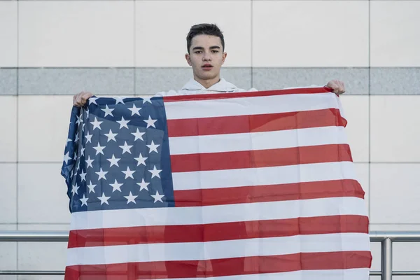 Young boy with the American flag on the street