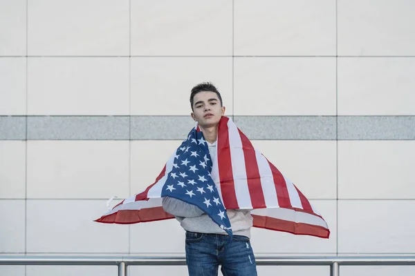 Young boy with the American flag on the street