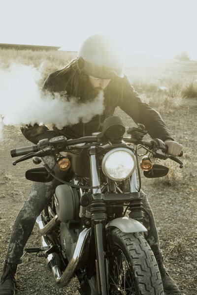 Man smoking with motorcycles on the off road