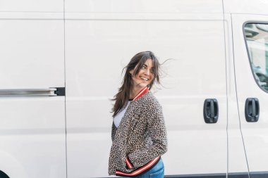 Güzel, mutlu, esmer bir kadın. Şehir caddesinde gülümsüyor..