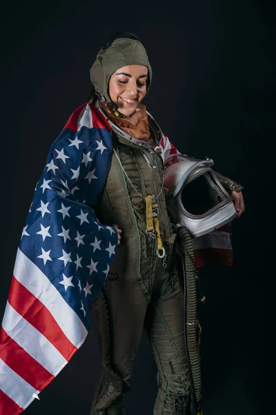 Young astronaut woman with helmet and flag of U.S.A