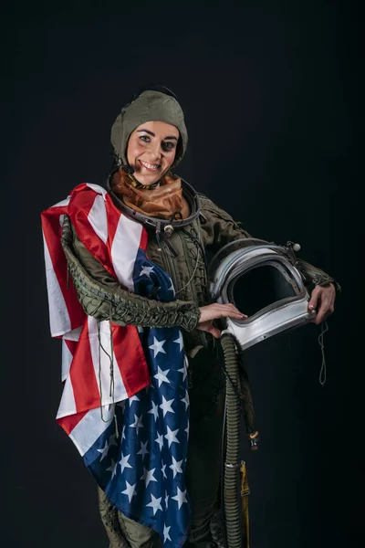 Young astronaut woman with helmet and flag of U.S.A