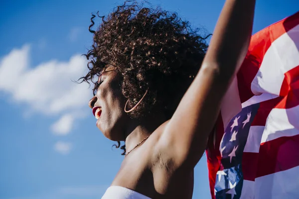 Mujer negra con el pelo afro y una bandera americana celebrando el día de la independencia de EE.UU. — Foto de Stock