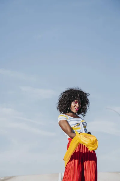 Afro woman with a yellow coloured scarf on the street — Stock Photo, Image