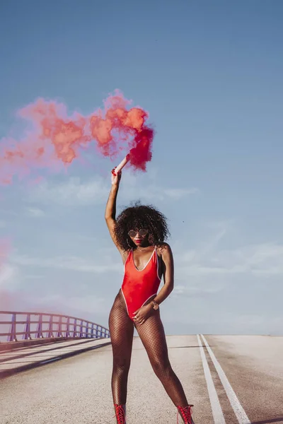 Young afro woman with red smoke bomb — Stock Photo, Image