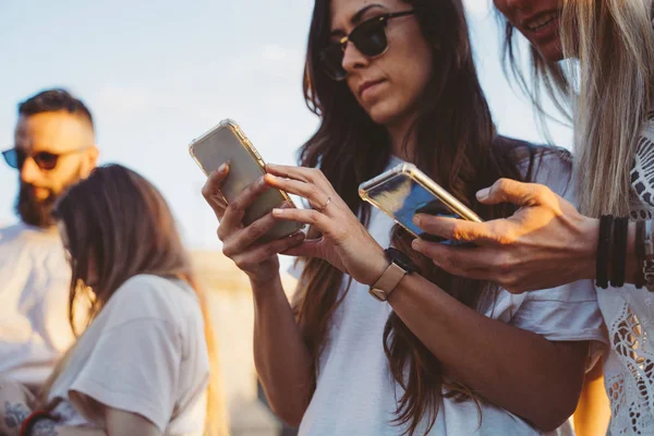 Group of friends watching media on a smartphone — Stock Photo, Image