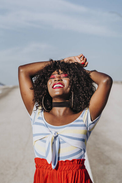 Beautiful afro american woman sticking out tongue in the street — Stock Photo, Image