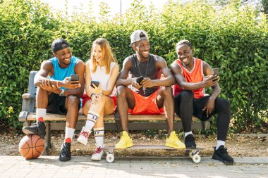 Sokakta cep telefonu kullanan bir grup arkadaş