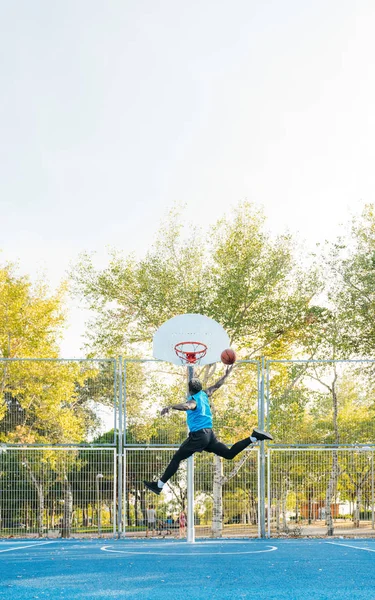 Junger Afro-Mann spielt auf dem Street-Basketballplatz — Stockfoto