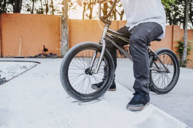 Bmx bisikletiyle paten parkında duran tanınmamış bir adam..