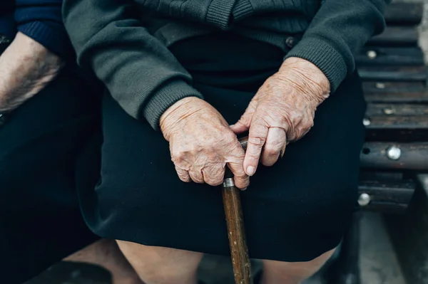 Ruce s vycházkovou holí od staré ženy — Stock fotografie