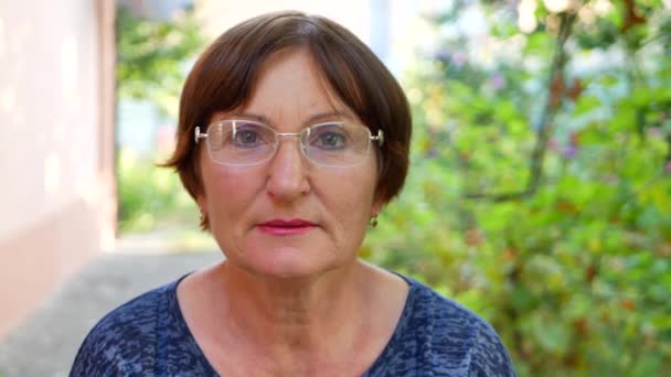 Portrait of elderly woman with eyeglasses has eyesight problems — Stock Video