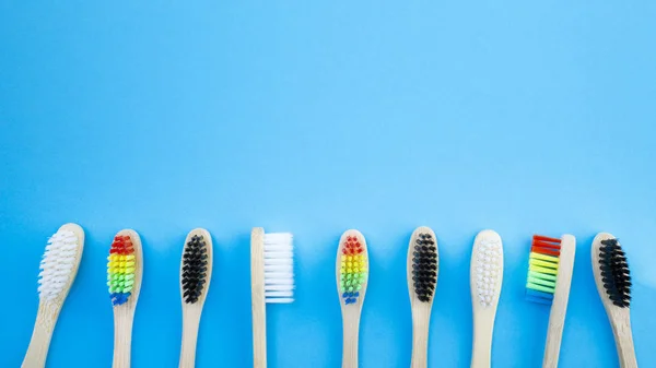 Black White Rainbow Bamboo Toothbrushes Blue Background Concept Racism Social — Stock Photo, Image