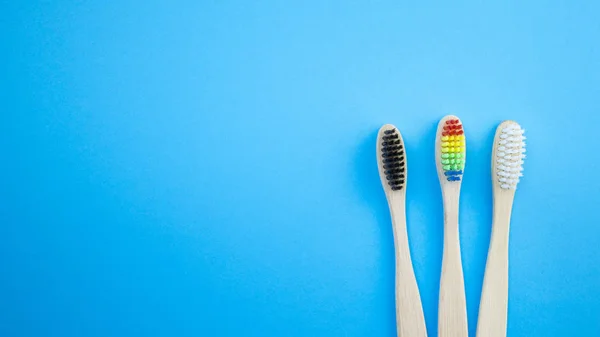 Black White Rainbow Bamboo Toothbrushes Blue Background Concept Racism Social — Stock Photo, Image