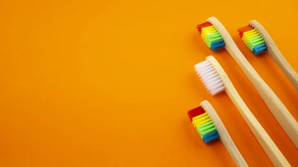 White Rainbow Wooden Toothbrushes Orange Background Concept Racism Social Exclusion — Stock Photo, Image