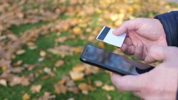 Man using mobile smartphone and credit card — Stock Video