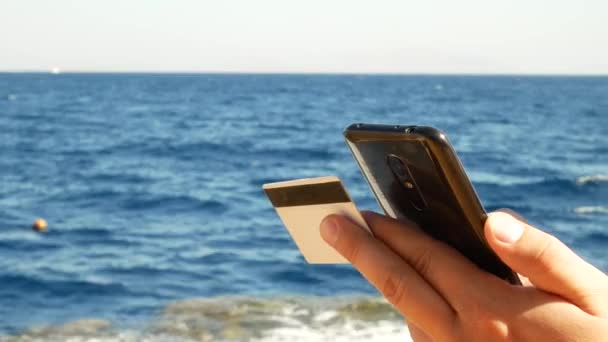 Young man shopping online with credit card and smartphone — Stock Video