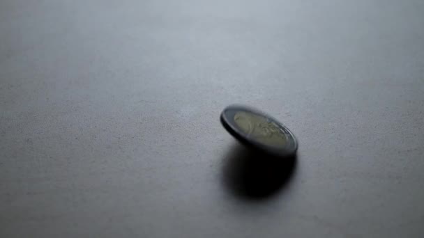 Two euro coin falling down on table — Stock Video