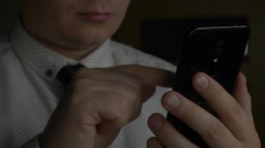 Yöneticisi veya işadamı kravat siyah smartphone kullanarak ile beyaz gömlekli