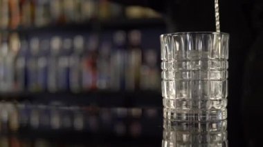 Barmen büyük buz küpü ile alkollü içki yapma