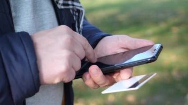 Hareket eden smartphone ve kredi kartı kullanan adam