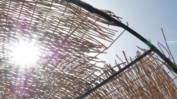 阳光透过海滩上的遮阳伞闪耀 — 图库视频影像