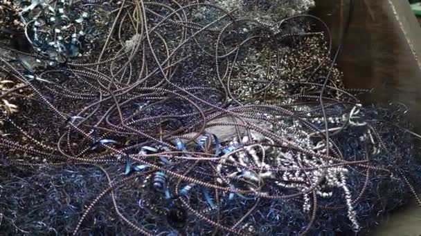 Colored spiral of metal shavings as debris from metal lathe machine — Stock Video