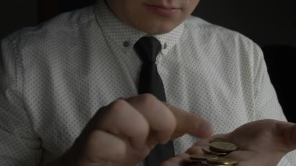 Businessman or manager counting coins in hands — Stock Video