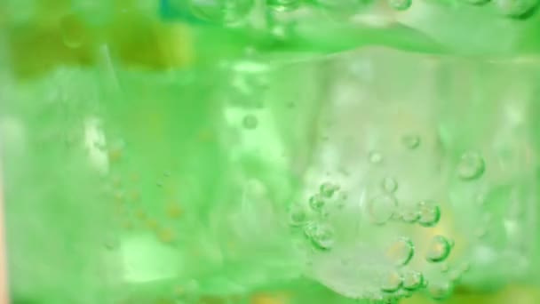 Air Bubbles Inside Glass of Sparkling Green Water — Stock Video