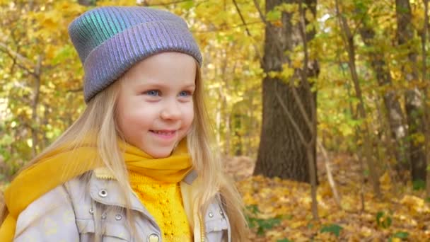 Little Girl Child Smiles in Park in Autumn — Stock Video